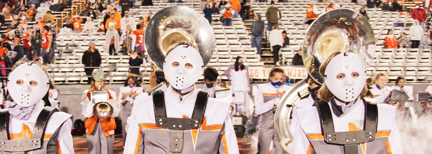Sound of the Swarm percussionists wear slightly less traditional face coverings for a postgame performance Oct. 30 just prior to Halloween.